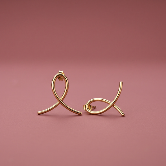 Abstract ribbon loop stud earrings in polished yellow gold with crossed tubular loop design