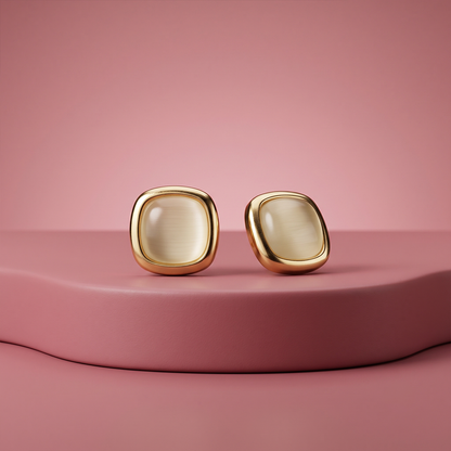 Gold plated square cabochon stud earrings with warm cream cat-eye stone and rounded corners