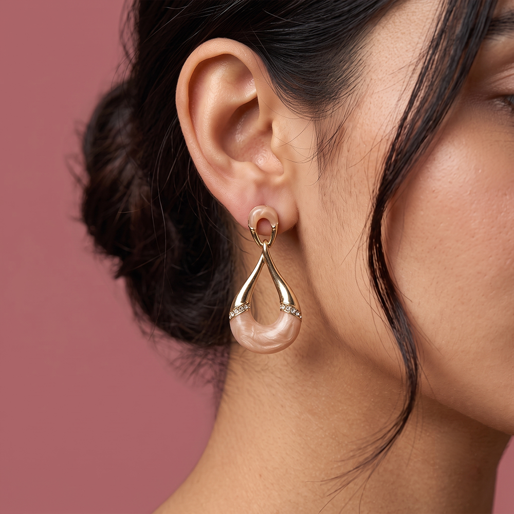 Gaurangi gold plated drop earrings with pearl detail worn on a woman