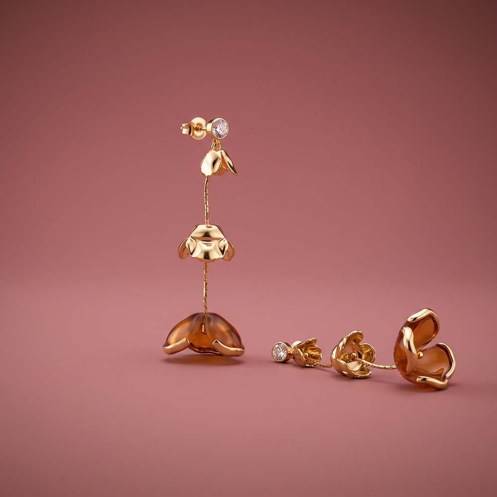 Gold plated three-tier amber floral drop earrings with clear faceted stone, 5.5cm articulated design