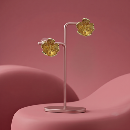 Gold plated floral stud earrings with sculpted five-petal flower design displayed on a jewelry stand