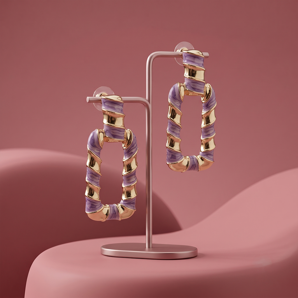 Gold plated purple enamel geometric drop hoop earrings displayed on a jewelry stand