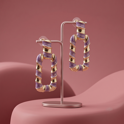 Gold plated purple enamel geometric drop hoop earrings displayed on a jewelry stand