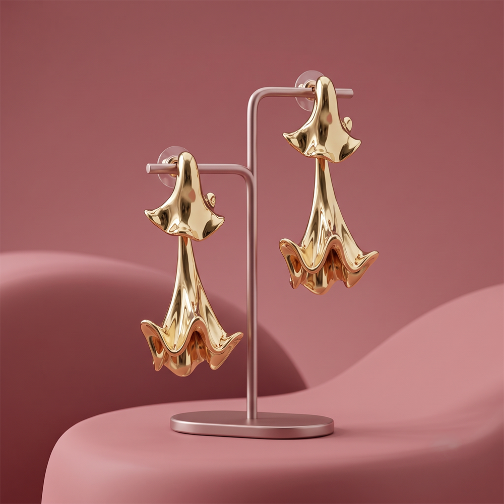Gaurangi gold plated statement drop earrings displayed on a luxury jewellery stand