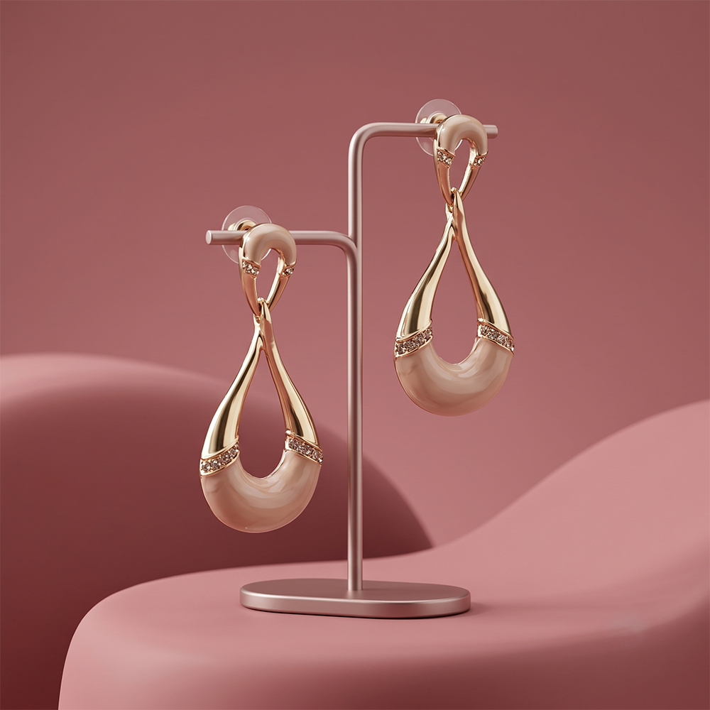 Gaurangi gold plated pearl drop earrings displayed on a luxury jewellery stand